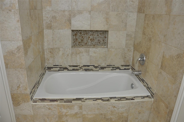 bathroom with tiled bath