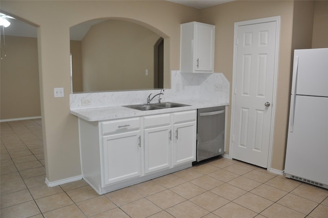 kitchen featuring stainless steel dishwasher, white fridge, tasteful backsplash, white cabinetry, and sink