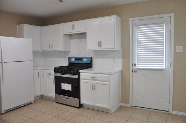 kitchen with white fridge, stainless steel range with gas stovetop, and white cabinetry