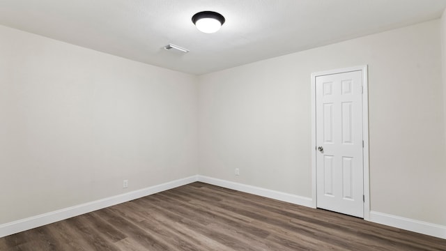 unfurnished room with dark hardwood / wood-style floors