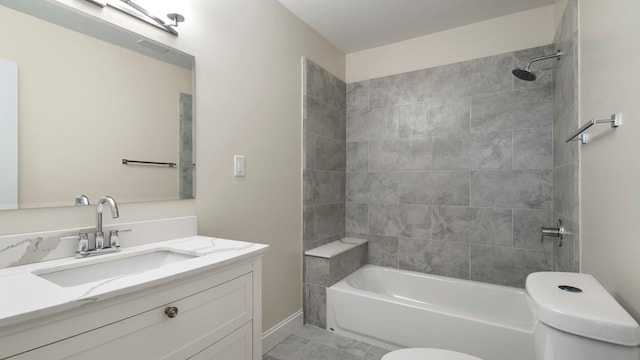 full bathroom featuring vanity, tile patterned flooring, tiled shower / bath combo, and toilet