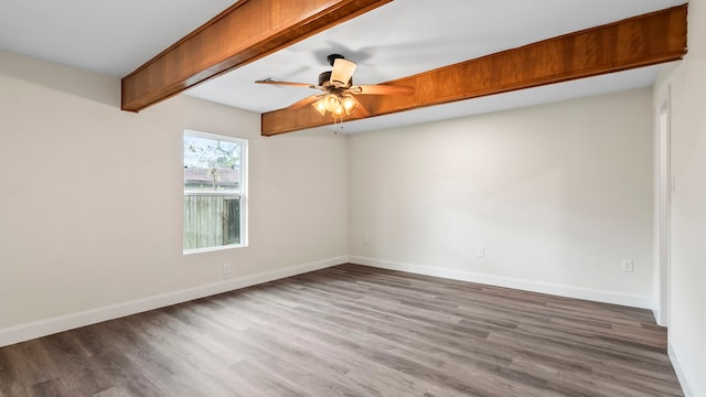 empty room featuring ceiling fan, hardwood / wood-style flooring, and beam ceiling