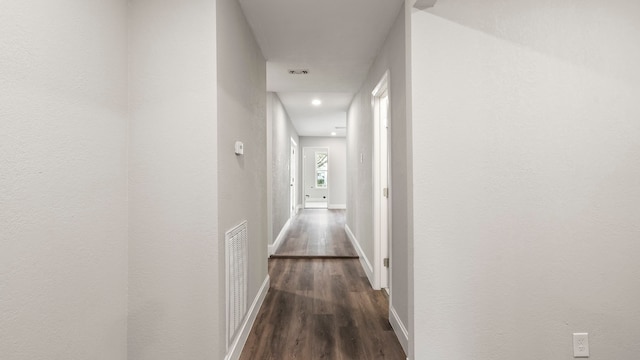 hallway featuring dark hardwood / wood-style flooring