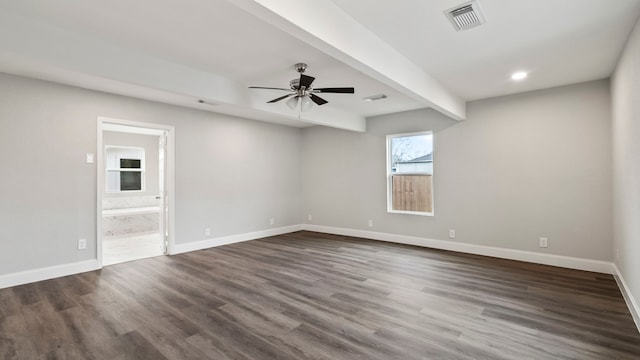 spare room featuring dark hardwood / wood-style floors, ceiling fan, and beam ceiling