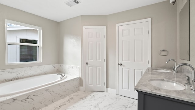 bathroom with vanity and tiled bath