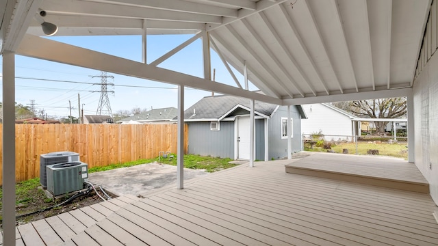 deck featuring a storage shed and central AC unit