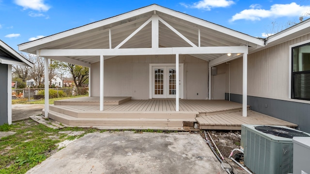 exterior space with a patio, french doors, and cooling unit