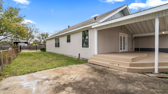 view of home's exterior featuring a patio, a yard, and a wooden deck