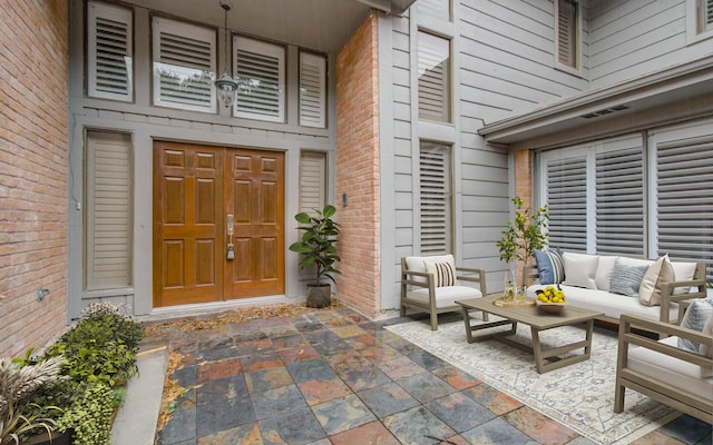 doorway to property with brick siding and outdoor lounge area