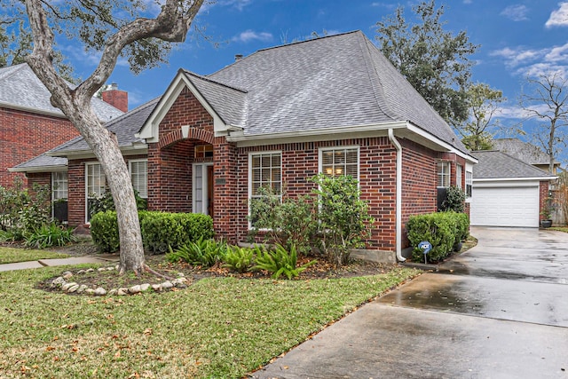 view of front of property with a garage and a front lawn