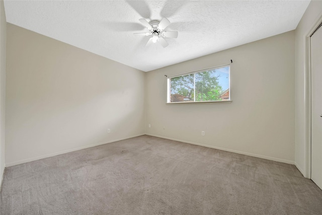 carpeted spare room with ceiling fan and a textured ceiling