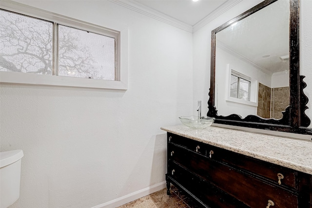 bathroom with toilet, ornamental molding, and vanity