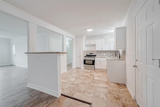 kitchen featuring white cabinets, stainless steel stove, light stone countertops, and crown molding