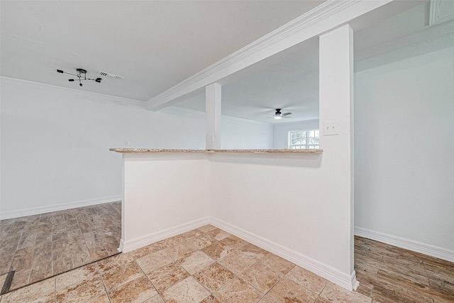 empty room featuring ceiling fan and ornamental molding