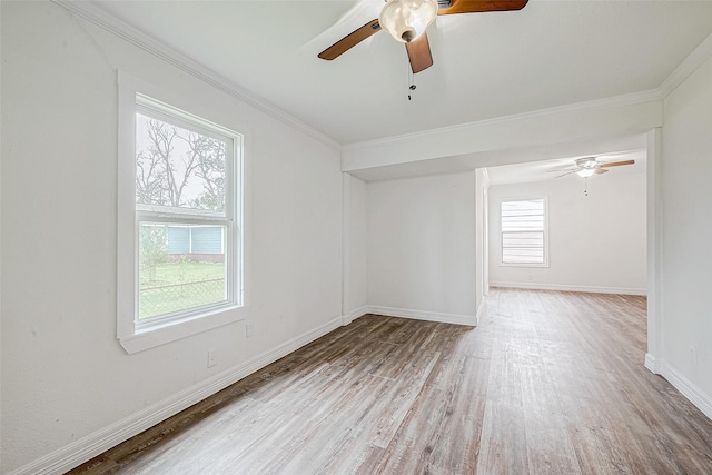 empty room featuring ceiling fan, hardwood / wood-style floors, and crown molding