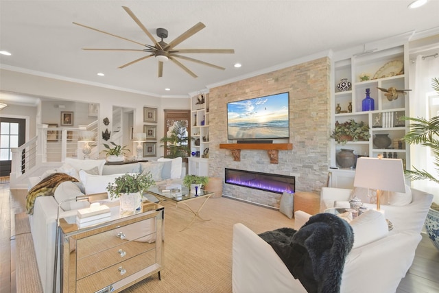 living room featuring a stone fireplace, ceiling fan, built in features, ornamental molding, and light hardwood / wood-style flooring