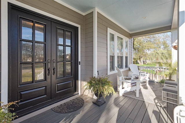 view of exterior entry with a porch