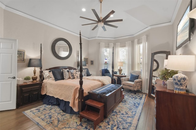 bedroom with ceiling fan, wood-type flooring, and crown molding