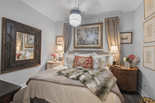 bedroom featuring ceiling fan, crown molding, and wood-type flooring