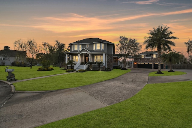 view of front of house featuring a lawn and a garage