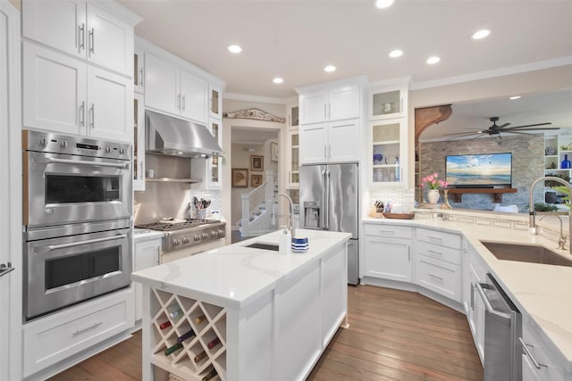 kitchen featuring white cabinets, decorative backsplash, appliances with stainless steel finishes, and sink