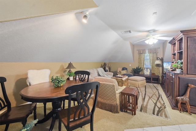 dining room with ceiling fan and vaulted ceiling