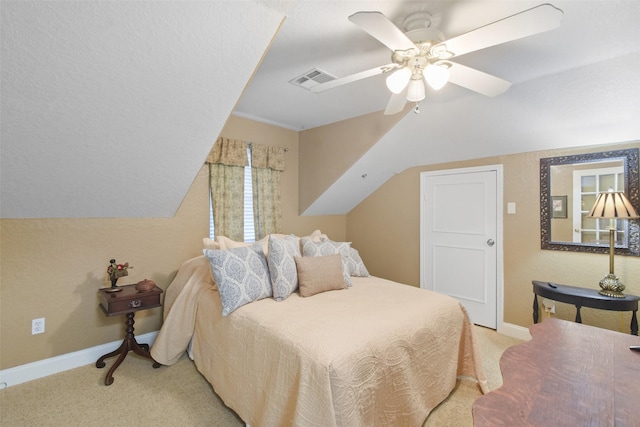 carpeted bedroom featuring ceiling fan and vaulted ceiling