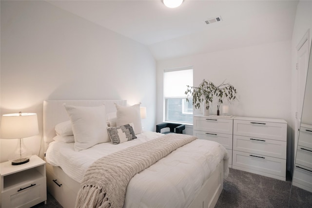 carpeted bedroom featuring vaulted ceiling