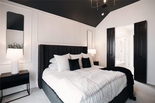 bedroom with lofted ceiling, ensuite bathroom, an inviting chandelier, and light carpet