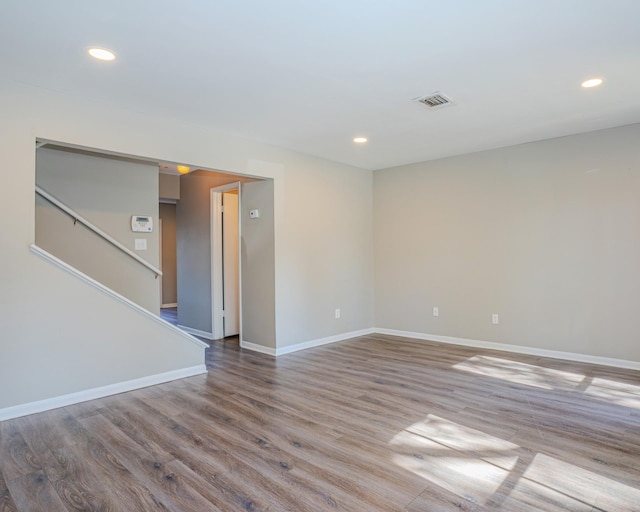 empty room with hardwood / wood-style flooring