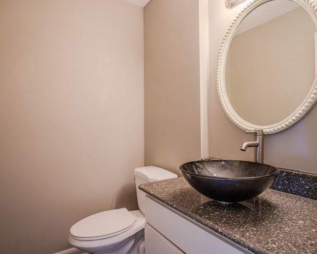 bathroom with toilet and vanity