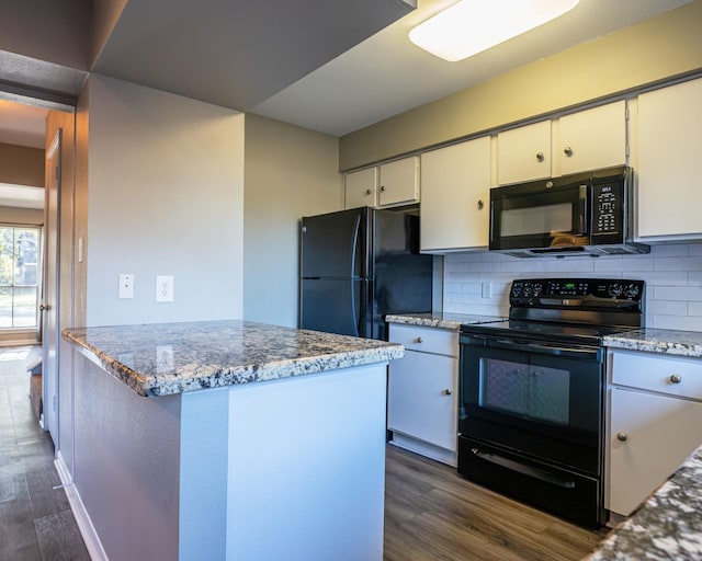 kitchen with black appliances, light stone counters, dark hardwood / wood-style floors, decorative backsplash, and white cabinetry