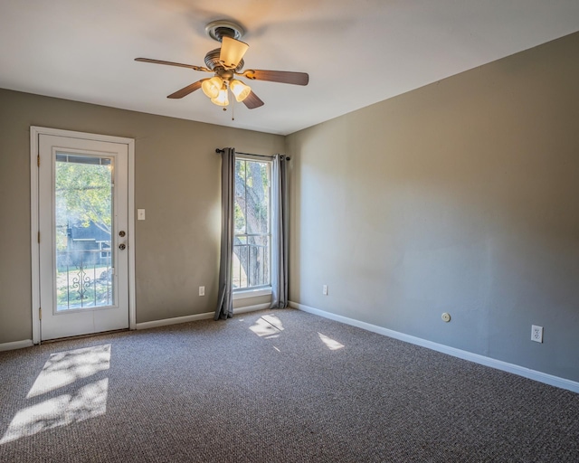 spare room featuring ceiling fan and carpet floors