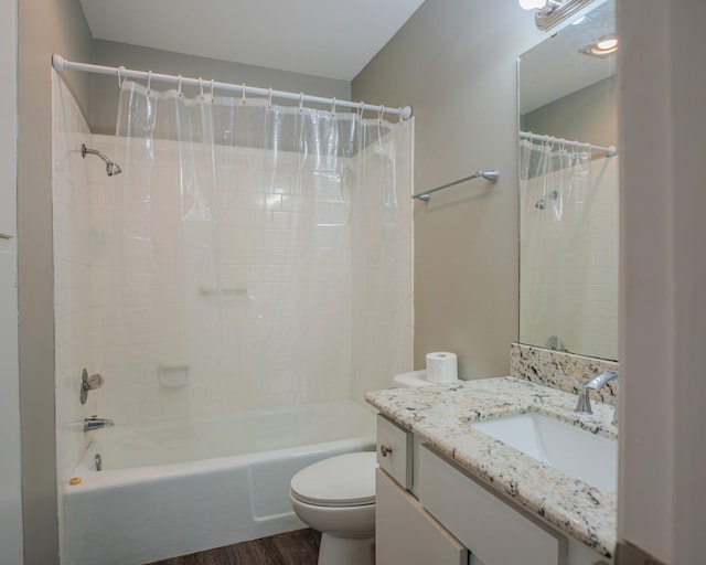 full bathroom featuring hardwood / wood-style floors, shower / tub combo with curtain, vanity, and toilet