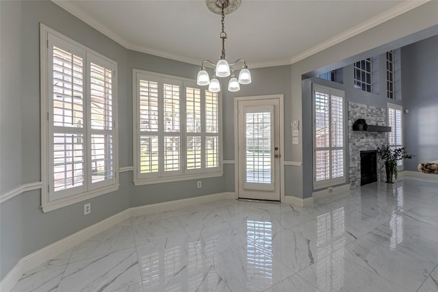 dining room with a fireplace, crown molding, and a notable chandelier