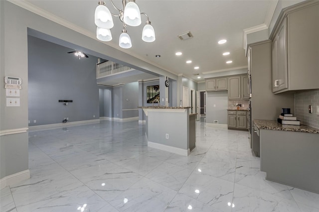 kitchen with ornamental molding, a chandelier, and tasteful backsplash