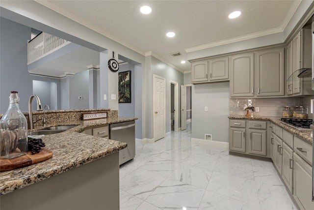 kitchen with gray cabinetry, stainless steel appliances, dark stone counters, sink, and tasteful backsplash