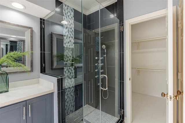 bathroom with vanity, walk in shower, and crown molding