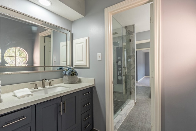 bathroom with vanity and a shower with shower door