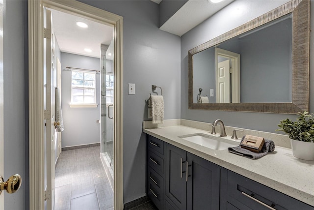 bathroom with an enclosed shower and vanity