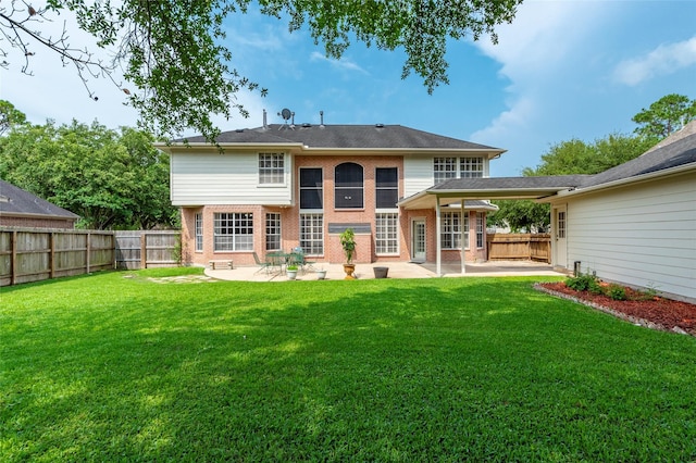 rear view of house featuring a patio and a yard