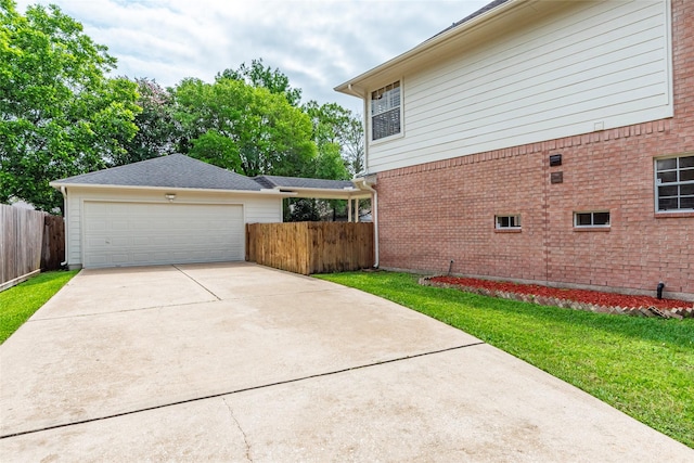 view of home's exterior featuring a lawn and a garage