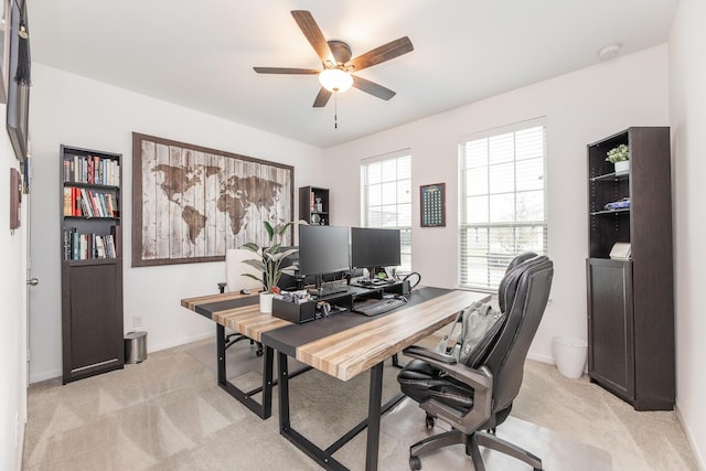 carpeted office featuring ceiling fan