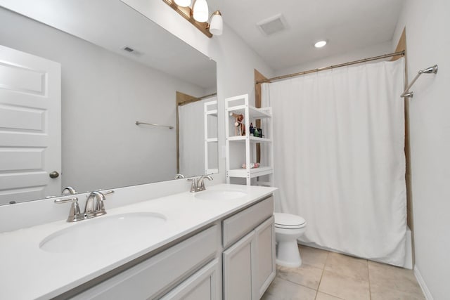 bathroom featuring toilet, tile patterned floors, and vanity