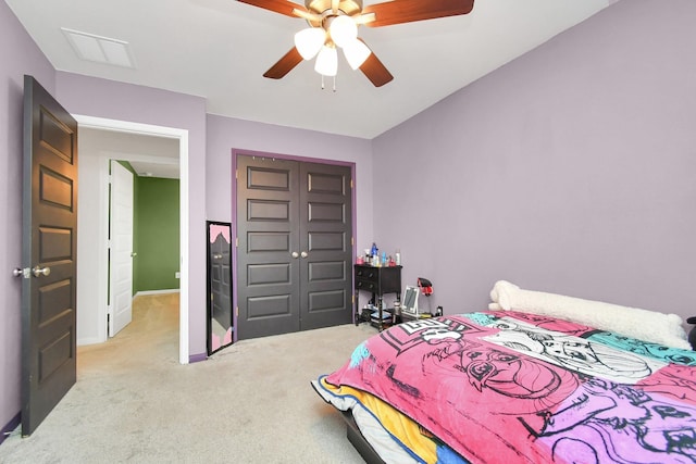 bedroom featuring light carpet, a closet, and ceiling fan