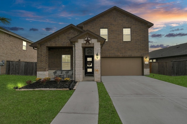 view of front of property with a yard and a garage