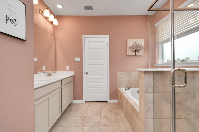 bathroom featuring shower with separate bathtub, vanity, and tile patterned floors