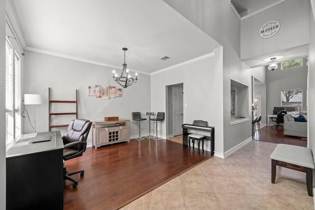 office area with light tile patterned floors, visible vents, baseboards, crown molding, and a notable chandelier