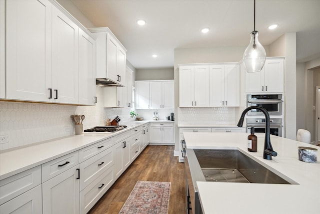 kitchen featuring sink, white cabinetry, pendant lighting, and appliances with stainless steel finishes