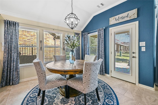 dining space with lofted ceiling, an inviting chandelier, and ornamental molding